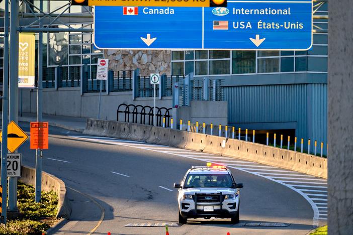 Canada plans to impose a new vaccine mandate on passengers and workers in the federally regulated air, rail and cruise ship sectors. Here, a police car is seen behind traffic cones in May near Vancouver International Airport in British Columbia.