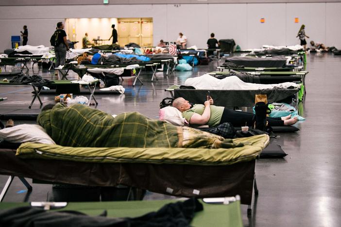 People rest at the Oregon Convention Center cooling station in Oregon, Portland on June 28, 2021, as a heatwave moves over much of the United States.