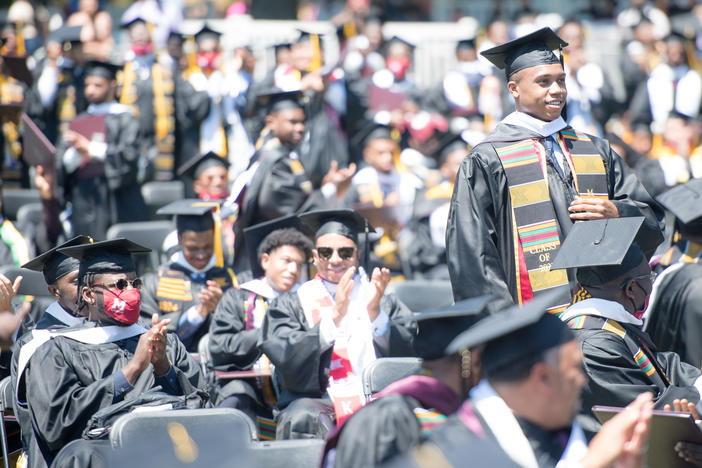 Students applaud at the Morehouse College commencement ceremony on May 16, 2021, in Atlanta. Morehouse recently announced it would clear remaining tuition balances for students, joining several other HBCUs doing the same.