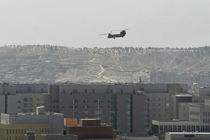 A U.S. military helicopter is pictured flying above the U.S. Embassy in Kabul on Sunday. The Taliban swept into Kabul, facing little resistance.