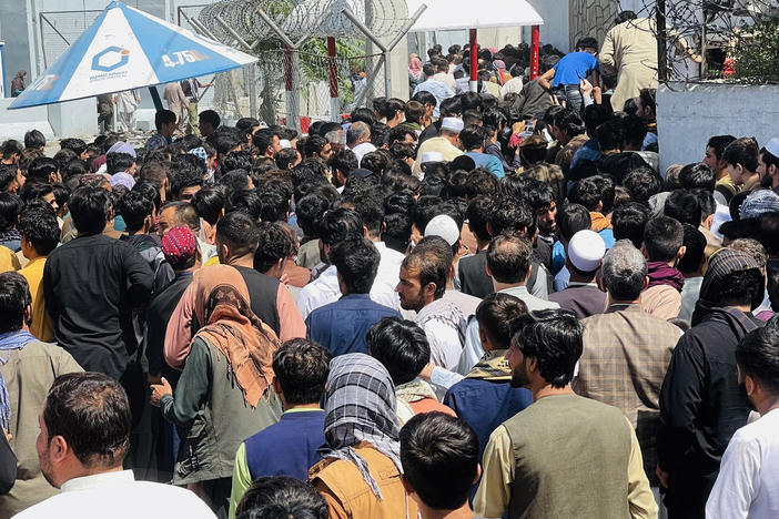 Afghans rush to the Hamid Karzai International Airport as they try to flee the Taliban takeover of Kabul.
