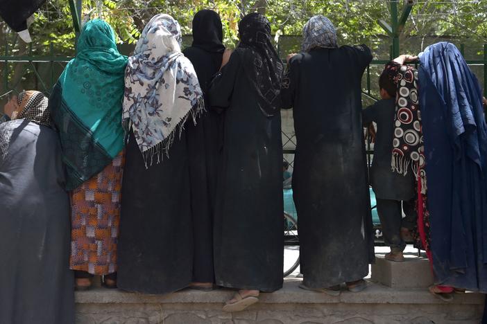 Internally displaced Afghan women, who fled because of battling between the Taliban and Afghan security forces, gather at Shahr-e-Naw Park in Kabul on Aug. 13.