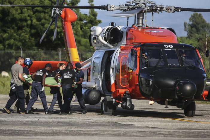 A person injured in the earthquake is transferred to a US Coast Guard helicopter in Les Cayes, Haiti, Monday, Aug. 16, 2021, two days after a 7.2-magnitude earthquake struck the southwestern part of the country.