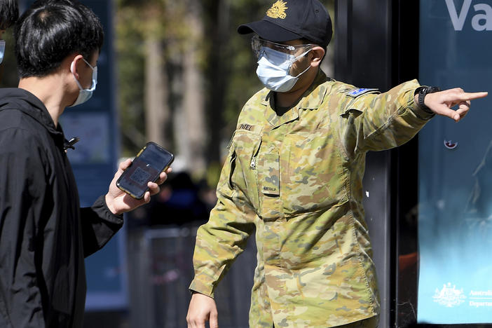 Australian Defense Force personnel assist the public at a COVID-19 vaccination clinic in Sydney, Wednesday, Aug.18th. Australia's most populous state reported a record 633 new infections on Wednesday.