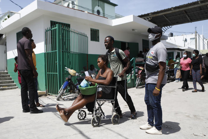 A woman seeks treatment for her injuries at the Immaculée Conception Hospital in Les Cayes, Haiti, on Wednesday.