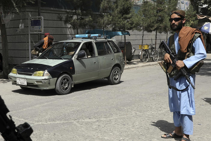 Taliban fighters stand guard at a checkpoint in the city of Kabul, Afghanistan, Wednesday, Aug. 18, 2021. The Taliban declared an "amnesty" across Afghanistan Tuesday seeking to convince a wary population that they have changed.