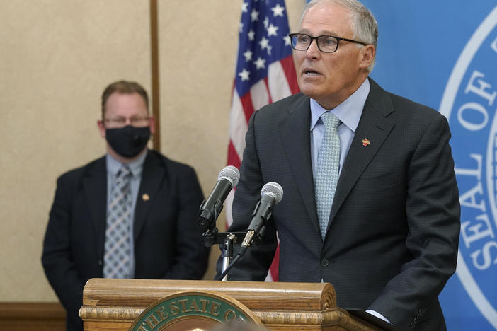 Washington Gov. Jay Inslee speaks at a news conference Wednesday at the state Capitol in Olympia. Inslee announced that Washington state is expanding its vaccine mandate to include all public, charter and private school teachers and staff as well as those working at the state's colleges and universities.