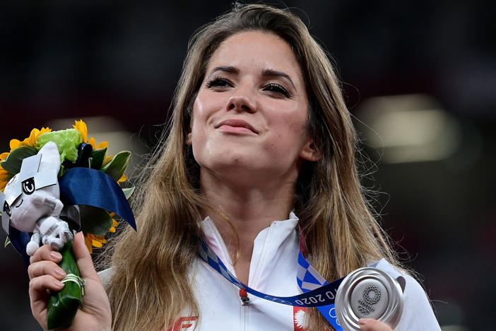 Poland's Maria Magdalena Andrejczyk celebrates her silver medal in the javelin throw at the Olympic Stadium in Tokyo on Aug. 7. She auctioned the medal to help fund heart surgery for an 8-month-old; the buyer decided to let her keep it.