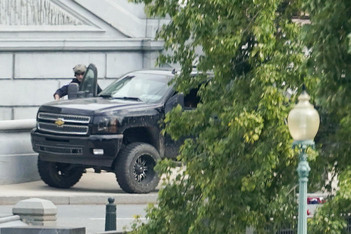 A man who claimed to have a bomb in a pickup truck near the Capitol surrendered to law enforcement after an hours-long standoff Thursday. The incident prompted a massive police response and the evacuations of government buildings and businesses in the area.