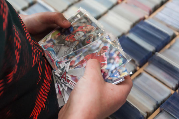 A young fans searches through Topps Baseball cards prior to the game between the Los Angeles Angels and the Kansas City Royals on Sunday April 28, 2019, at Kauffman Stadium in Kansas City, Mo.