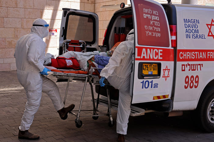 Medics in Jerusalem transfer a COVID-19 patient to Hadassah Hospital Ein Kerem. Many hospitals in Israel are at full capacity following a sharp increase in coronavirus infections.