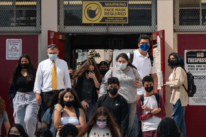 Students and staff exit Hollywood High School after the first day of school in Los Angeles.