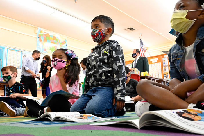 First-graders listen to the interim superintendent of the Los Angeles Unified School District, Megan Reilly, read a book at Normont Elementary School in Harbor City on Aug. 16, the first day of school.