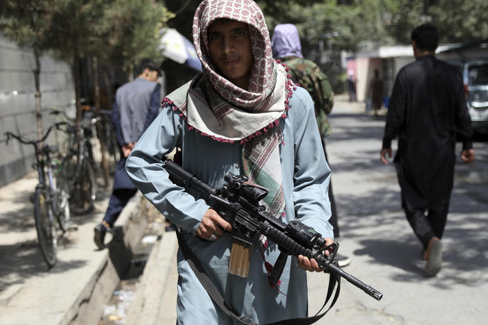 A Taliban fighter stands guard at a checkpoint in the Wazir Akbar Khan neighborhood in the city of Kabul, Afghanistan, on Sunday.