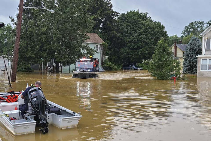 In this photo provided by Mayor Chris Slavicek, emergency personnel and first responders look to rescue any residents who need help after heavy rains from Henri flooded the area on Sunday in Helmetta, N.J.