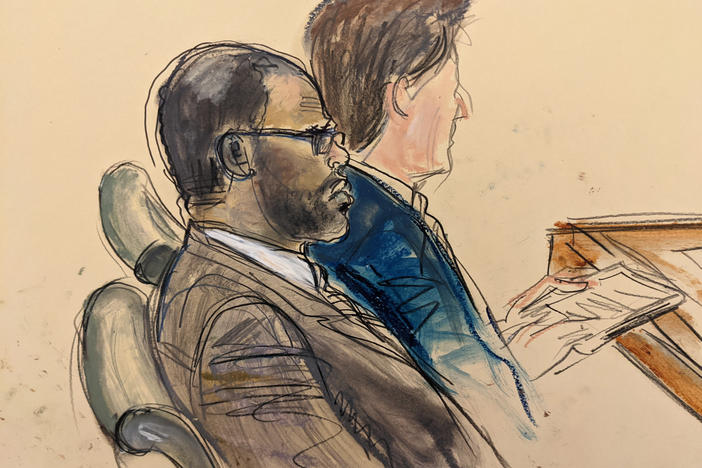 In courtroom artist's sketch made from a video screen monitor, defendant R. Kelly, left, listens during the opening day of his New York federal trial in Brooklyn on Aug. 18.