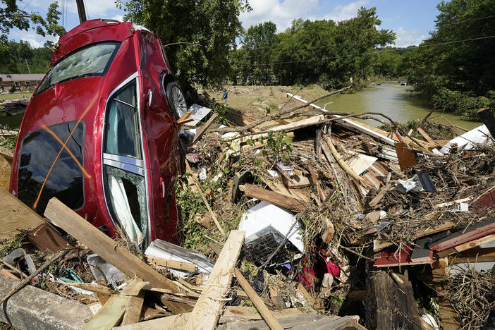 Debris could be seen piled up in Waverly, Tenn., on Sunday after heavy weekend rains caused deadly flash flooding. Climate change is driving more torrential rain around the world.