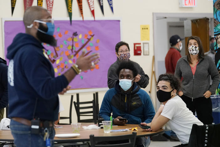 Principal Malik Lewis, second from left, is pictured at West Brooklyn Community High School in New York City in October 2020. All New York City public school teachers and other staffers will have to get vaccinated against the coronavirus, officials said Monday, as the nation's largest school system prepares for classes to start next month.