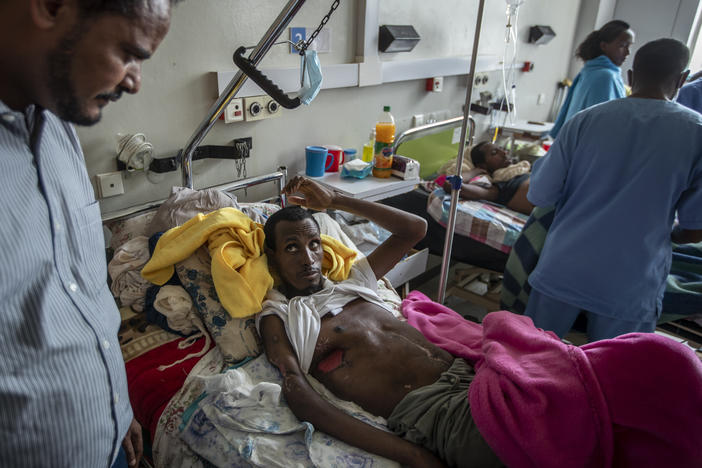 In a May 6, 2021 file photo, a farmer, Teklemariam Gebremichael, who said he was shot by Eritrean forces in Enticho six months before and is still recovering, speaks to a doctor, left, at the Ayder Referral Hospital in Mekele, in the Tigray region of northern Ethiopia. The United States on Monday imposed sanctions on Eritrea's chief of staff of the defense forces.