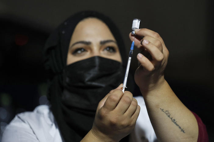 An Israeli health worker prepares to administer a third dose of the Pfizer-BioNtech Covid-19 vaccine to Jewish ultra-Orthodox people at a religious neighborhood in Jerusalem on August 19, 2021.