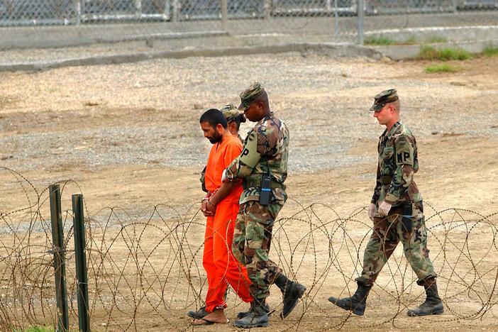 Marines transport a detainee in Guantánamo Bay, Cuba, in 2002. Nearly 800 detainees have passed through the prison since it opened that year. Today, 39 men are still being held there.