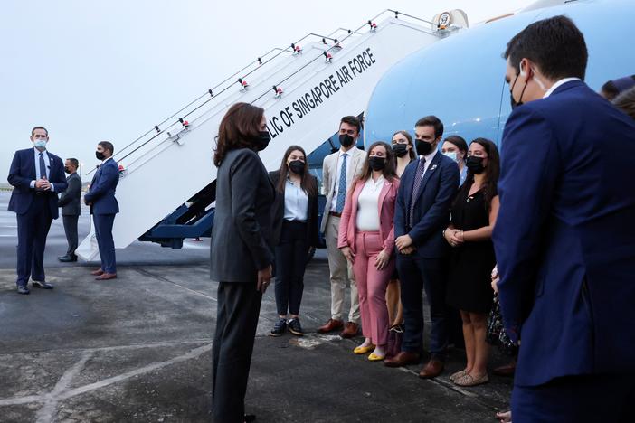 Vice President Harris (center) speaks with U.S. personnel as she departs Tuesday from Singapore on her way to Vietnam.