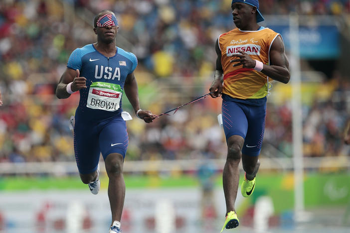 David Brown (left) runs the men's 100 meter T11 round 1 on day 3 of the Rio 2016 Paralympic Games on September 10, 2016 in Rio de Janeiro, Brazil. He is competing in Tokyo with a new partner, Moray Steward.