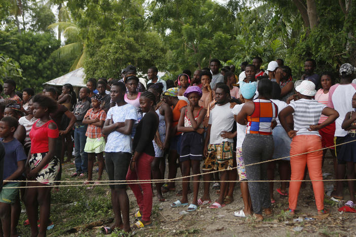 Families wait to receive humanitarian aid from a U.S. Army helicopter unit in the town of Anse-A-Veau, Haiti, on Wednesday.