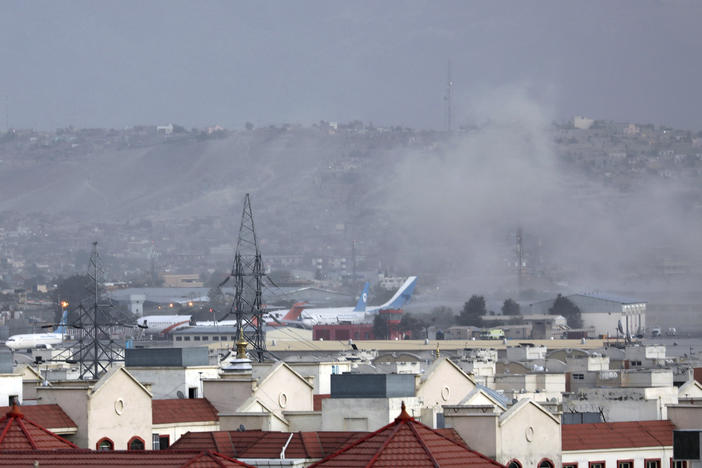 Smoke rises from explosion outside the airport in Kabul, Afghanistan on Thursday. Reports of explosions outside the airport were confirmed the following morning.