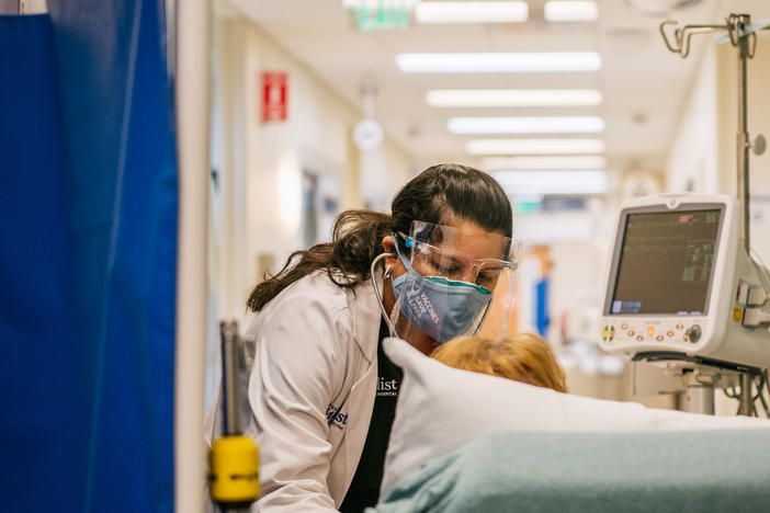An emergency room nurse tends to a patient in a hallway last week at the Houston Methodist The Woodlands Hospital in Houston.