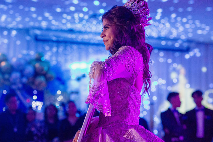 Citlaly Olvera Salazar dances with an image of her grandfather, Antonio Salazar, and father, Cesar Olvera, in their absence during her Quinceañera.