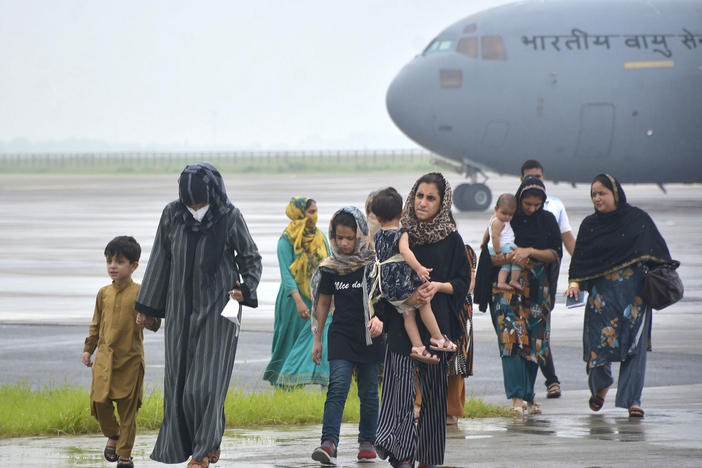 People evacuated from Kabul arrive at Hindon Air force base near New Delhi, on Aug. 22.