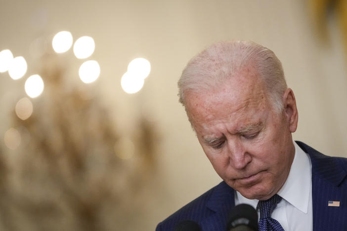 President Biden bows his head in a moment of silence Thursday as he speaks about the situation in Afghanistan from the White House's East Room.