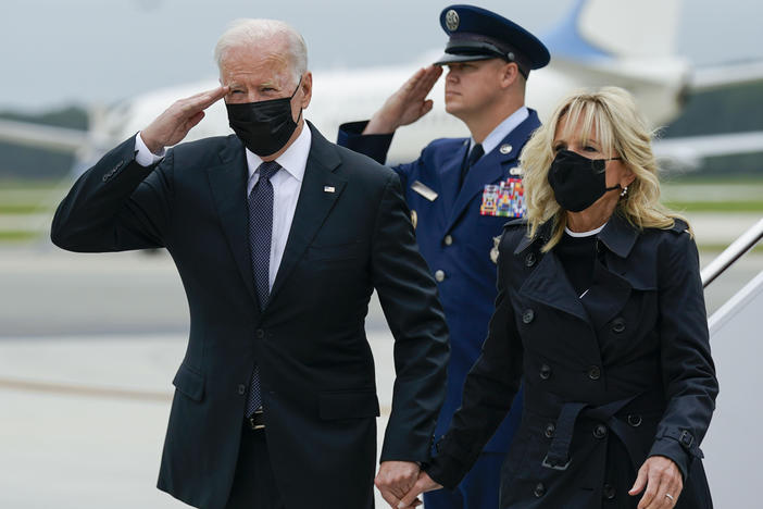 President Biden returns a salute as he and first lady Jill Biden arrive at Dover Air Force Base, Del., Sunday, Aug. 29, 2021. Biden embarked on a solemn journey Sunday to honor and mourn the 13 U.S. troops killed in the suicide attack near the Kabul airport as their remains return to U.S.