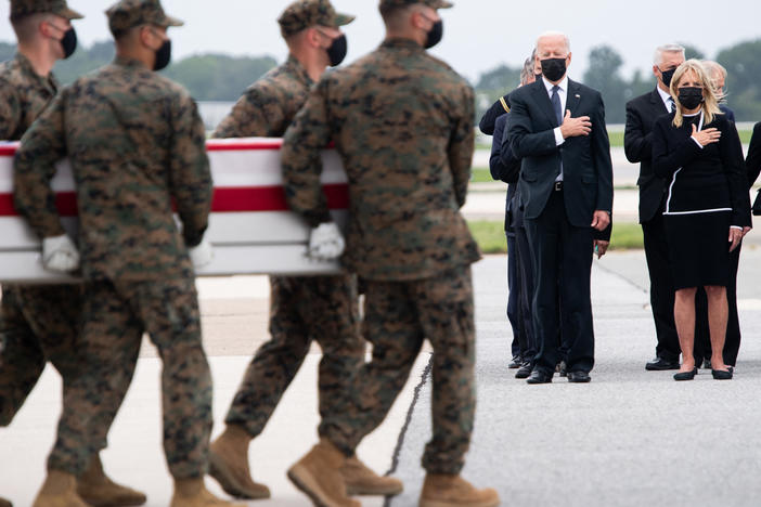 President Biden attends the dignified transfer of the remains of a fallen service member at Dover Air Force Base in Dover, Del., on Sunday.