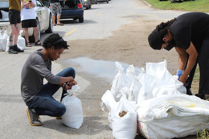 New Orleans residents Jordan Bridges and David Jones pack sandbags as they prepare to ride out the storm. Bridges described Katrina as a "stain" on the city's soul.