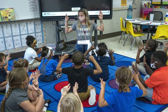 Nashville, Tenn., kindergarten teacher Amber Updegrove leads her class in a lesson this month. On Monday, the U.S. Department of Education announced an investigation into Tennessee's requirement that schools allow families to opt out of mask mandates.