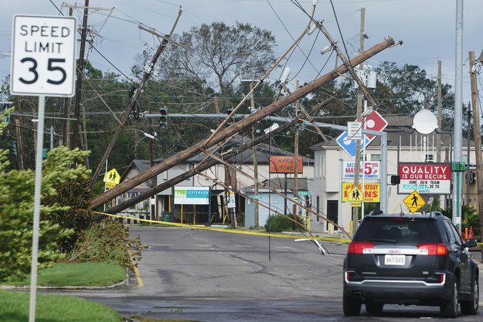Hurricane Ida leaves downed power lines in its wake Monday in Metairie, La. The one-two punch of a natural disaster and the pandemic is complicating efforts to evacuate hospitals, seek shelter and administer COVID-19 vaccines.