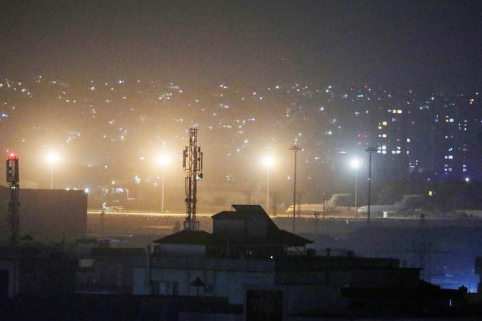 Planes are seen on the tarmac at the airport in Kabul late on August 30, 2021, hours ahead of the U.S. deadline to complete its frenzied withdrawal from Afghanistan.