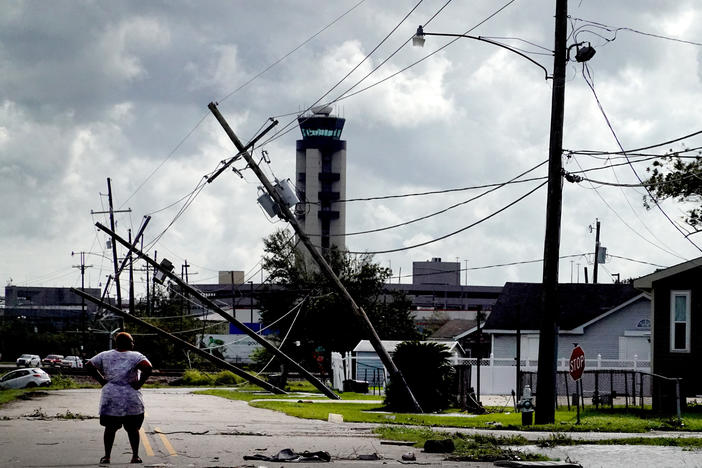 A woman surveys damage Monday from Hurricane Ida in a neighborhood in Kenner, La. The storm was fueled by abnormally warm water in the Gulf of Mexico.