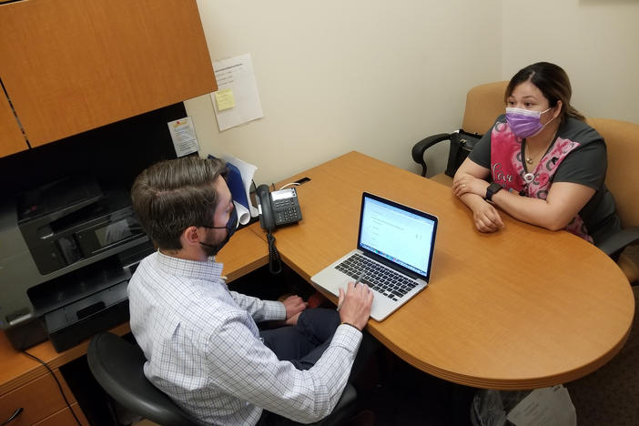 Attorney Marc Scanlon meets with client Kimberly Ledezma at Salud Family Health Centers' clinic in Commerce City, Colo. Every day in this Denver suburb, four lawyers join the clinic's physicians, psychiatrists and social workers to consult on cases, as part of the clinic's philosophy that mending legal ills is as important for health as diet and exercise.