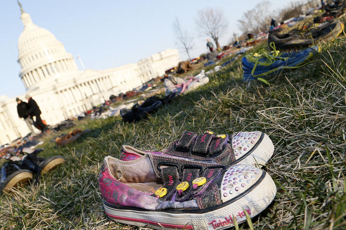 Thousands of empty empty pairs of shoes for every child killed by guns in the U.S. since Sandy Hook cover the southeast lawn of U.S. Capitol on March 13, 2018, in Washington, D.C.