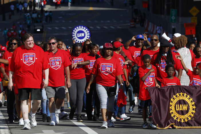 United Auto Workers members walk in the Labor Day parade' in Detroit, Monday, Sept. 2, 2019.