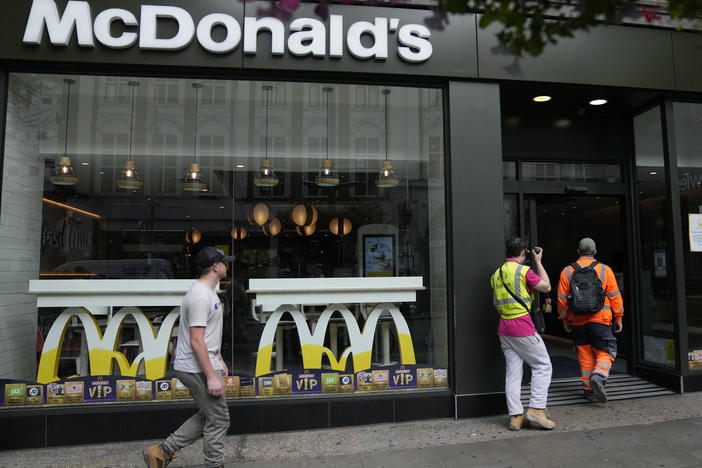 Customers walks into a McDonald's restaurant, in London on Aug. 24. McDonald's says it has pulled milkshakes from the menu in all 1,250 of its British restaurants because of supply problems stemming from a shortage of truck drivers.