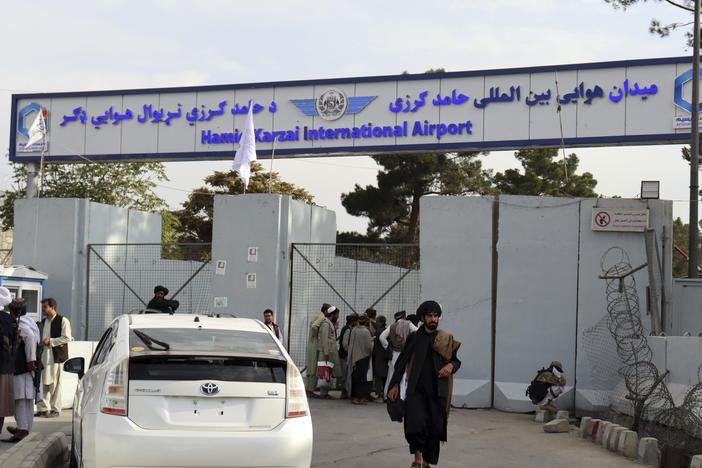 Taliban fighters stand guard in front of the Hamid Karzai International Airport after the U.S. withdrawal in Kabul, Afghanistan.