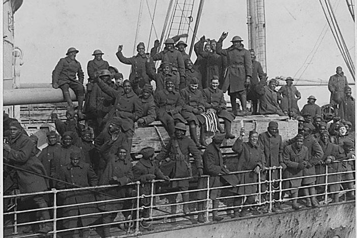 Members of New York's famous 369th Infantry Regiment wave as they come back home from France.