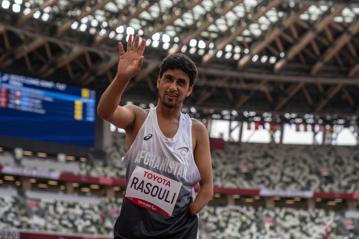 Hossain Rasouli of Team Afghanistan waves after competing in the Men's Long Jump-T47 Final at the Tokyo Olympic Stadium on Tuesday. He and teammate Zakia Khudadadi managed to get to Tokyo despite the turmoil in their home country.