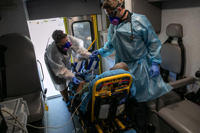 Medics transport a man with COVID-19 symptoms to a hospital in Austin, Texas. More than 3 million people in the state have had COVID-19, but just 81,000 are listed in a central data set at the Centers for Disease Control and Prevention.