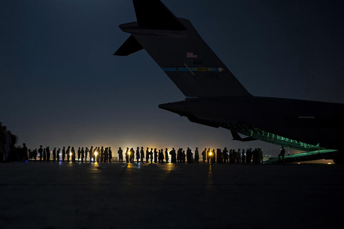 A U.S. Air Force air crew prepares to load evacuees aboard a C-17 aircraft at Hamid Karzai International Airport in Kabul, Afghanistan, on Aug. 31. Several public school students from Sacramento, Calif., remain in Afghanistan since the U.S. evacuation ended.