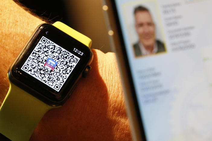 A person scans a QR Code on an Apple Watch to send a digital driver's license temporarily to another mobile phone last month in Salt Lake City. Utah is among eight states that eventually will let users add a license or state ID to Apple Wallet.
